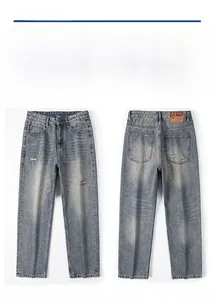 Detail view of denim jeans featuring a brown leather patch with 0877 embossed text