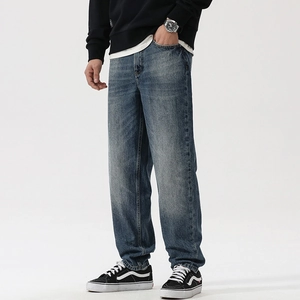 Vintage wash blue loose straight fit men's jeans with distressed details and heavy washing
