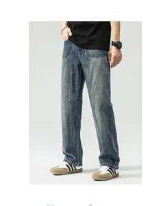 Detail of dark blue washed straight-leg jeans with vertical seam stitching for men
