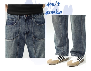 Close-up of deep blue washed jeans featuring vertical seam detailing and cat-whisker fading