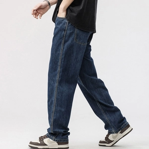 Side view of men's deep blue loose straight jeans with contrast stitching detail