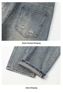 Detail of distressed back pocket and rolled cuffs on blue vintage wide-leg jeans