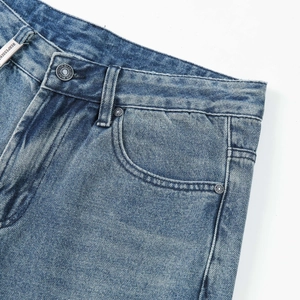 Light blue wide-leg denim jeans with stone wash effects and metal hardware details
