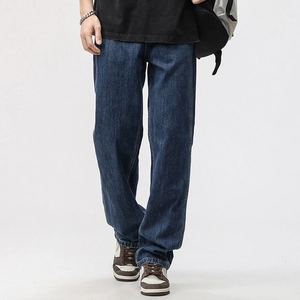 Detail showing the vintage washed dark blue denim texture and premium high-density fabric