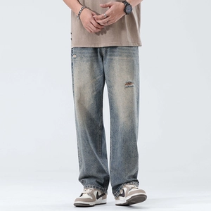 Vintage blue wide-leg jeans for men with distressed ripped details and retro wash finish