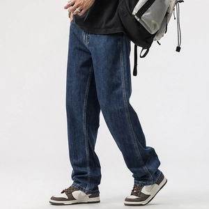 Detail of dark blue straight-leg jeans featuring visible topstitching and denim texture