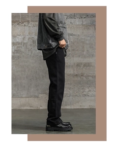 Dettaglio dei pantaloni in denim nero a zampa da uomo in cotone spesso in stile vintage
