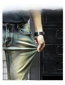 Detail of high-stretch vintage indigo denim fabric being pulled to show elasticity