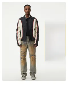 Detail of vintage washed denim jeans with distressed knee rips and street style straight fit