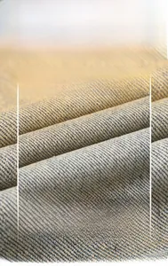 Detailed close-up showing the blue-grey twill denim fabric texture and high-density weave