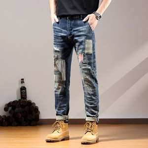 Men's deep blue patchwork distressed jeans with embroidery and vintage repair details