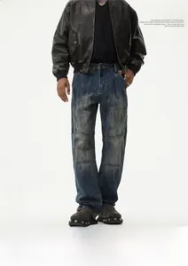 Detail of distressed dark blue straight-leg jeans with vintage patchwork design for men