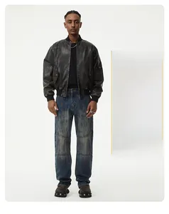 Detailed view of men's vintage washed blue patchwork straight jeans with distressed finish
