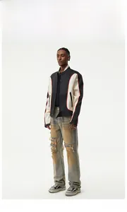 Detail of vintage yellow-wash distressed jeans with knee rips in a street racing outfit