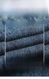 Detailed macro view of dark blue twill denim fabric texture with soft skin-friendly finish