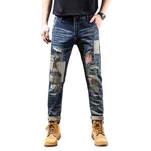 Slim fit distressed blue jeans for men with patchwork details and ripped denim texture