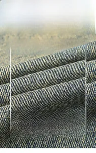 Macro shot of high-density navy twill denim fabric texture showing premium cotton fibers