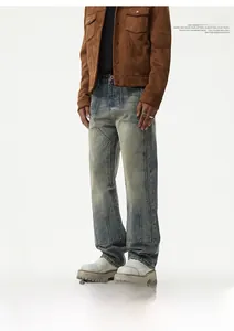 Detail of vintage washed straight denim pants with spliced stitching and paneled design