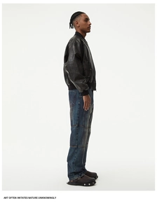 Men's retro distressed dark leather jacket styled with straight blue washed jeans