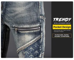 Detail view of retro washed denim jeans featuring metal zipper pocket and embroidery