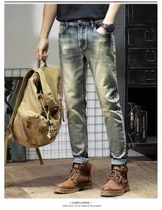 Close-up of vintage wash jeans with cat whisker patterns and distressed denim details