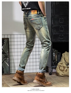 Detailed view of vintage blue jeans with W-stitch back pocket and leather waist patch