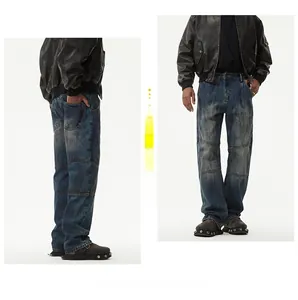 Detail of vintage distressed blue denim jeans with paneled knees and straight leg fit