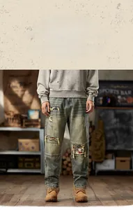 Detail of vintage distressed jeans featuring ethnic style ribbon patchwork and ripped holes