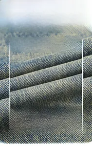 Macro view of blue and yellow twill denim fabric showing fine woven texture