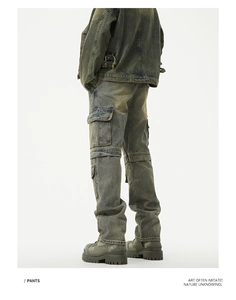 Detail of vintage washed denim workwear pants featuring side cargo pockets and a baggy fit