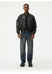Close-up of blue distressed straight jeans with panelled stitching and knee seam details