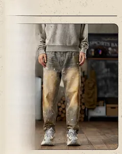 Detail of vintage washed denim with mud-staining effect and white paint splatters