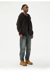 Detail of loose-fit washed blue jeans with oversized pockets in American street style