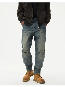Detail of heavy-wash blue denim pants with cargo pockets and diamond quilted stitching