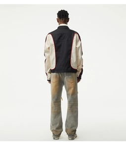 Rear view of loose fit vintage washed denim jeans paired with a bicolor worker jacket