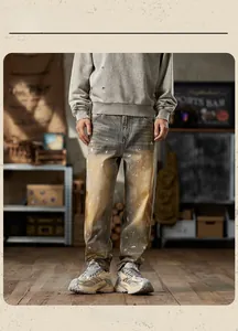 Detail of vintage washed denim with mud-tint finish and artistic white ink splatters
