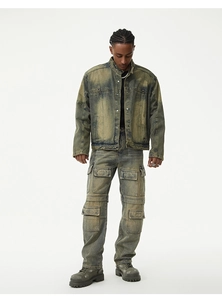 Detail of dirty wash denim texture and multiple cargo pockets on vintage workwear pants