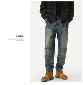 Detailed view of quilted cargo pockets and knee patches on vintage washed denim pants