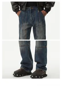 Detailed patchwork construction and vintage wash on high-street baggy denim jeans