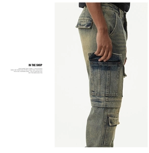 Detail of vintage washed denim jeans showing large cargo side pockets and textured fabric
