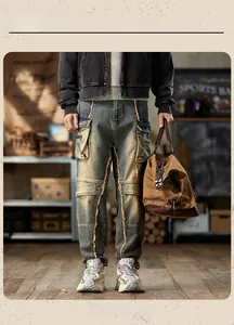 Detail of cargo jeans featuring distressed denim, yellow contrast stitching and multi-pockets
