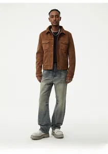 Detail of vintage blue washed loose straight jeans paired with a brown suede jacket
