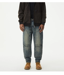 Detail of vintage washed blue denim cargo pants with quilted knee patches and pockets