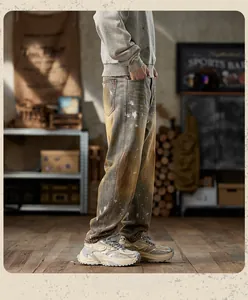 Detail of vintage yellow-wash baggy jeans with paint splatter and street style aesthetic