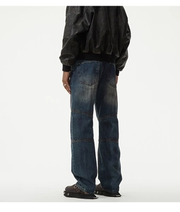 Rear view of distressed baggy jeans for men with unique triple-stitched knee seam design