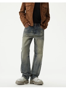 Close-up of retro washed denim jeans featuring knee patch details and straight leg cut