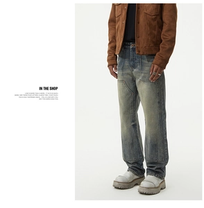 Detail of heavy washed vintage blue jeans with reinforced double knee panel design