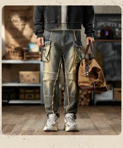 Detail of vintage washed denim cargo pants with yellow raw edge stitching and multi-pockets