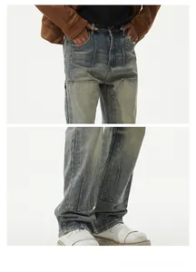 Close-up of retro washed denim jeans featuring double knee patches and vintage fading