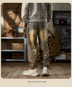 Detail of vintage American style cargo jeans with yellow mud wash and white paint splatters
